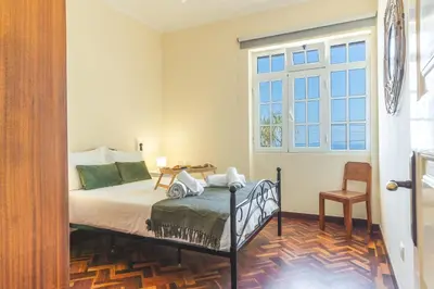 a bedroom with a bed and a window at Villa Santa Luzia 1 by Atlantic Holiday in Santa Luzia