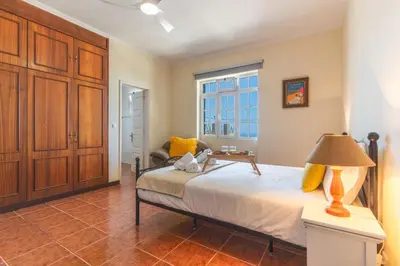 a bedroom with a bed with a lamp on a table at Villa Santa Luzia 1 by Atlantic Holiday in Santa Luzia