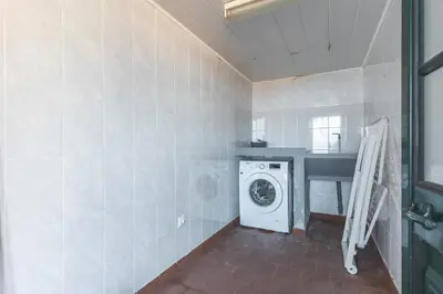 a laundry room with a washing machine in a room at Villa Santa Luzia 1 by Atlantic Holiday in Santa Luzia