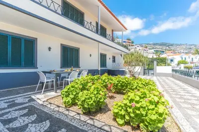 a patio of a house with a table and some plants at Villa Santa Luzia 1 by Atlantic Holiday in Santa Luzia