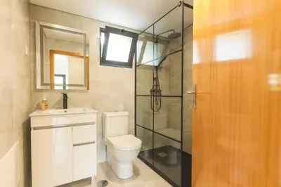 a bathroom with a toilet and a glass shower at Villa Lorenzo by Atlantic Holiday in São Vicente
