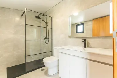 a bathroom with a shower and a toilet and a sink at Villa Lorenzo by Atlantic Holiday in São Vicente