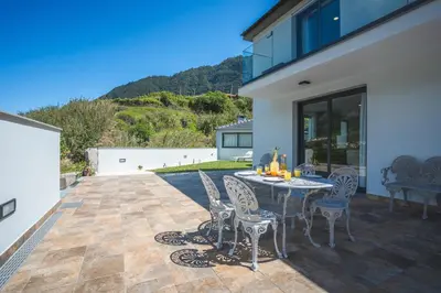 a patio with a table and chairs on it at Villa Lorenzo by Atlantic Holiday in São Vicente