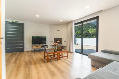 a living room with a couch and a tv at Villa Lorenzo by Atlantic Holiday in São Vicente