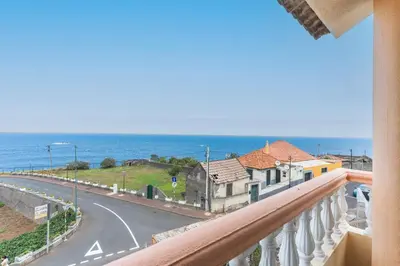 a balcony with a view of a road and the ocean at Villa Mar by Atlantic Holiday in Porto Moniz