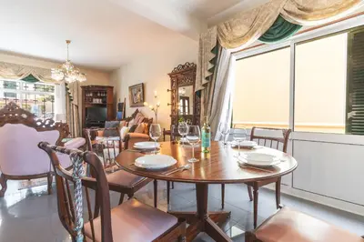 a dining room with a table and chairs and a large window at Villa Mar by Atlantic Holiday in Porto Moniz