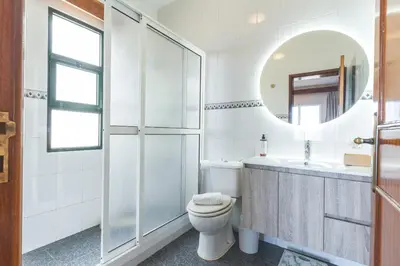a bathroom with a toilet and a sink and a mirror at Villa Mar by Atlantic Holiday in Porto Moniz