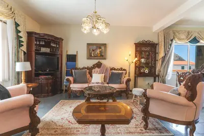 a living room filled with furniture and a chandelier at Villa Mar by Atlantic Holiday in Porto Moniz