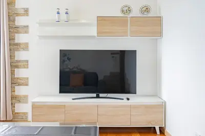a living room with a tv on a fireplace at atlantico view in Caniço