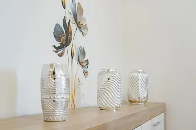 three vases sitting on top of a wooden shelf at atlantico view in Caniço