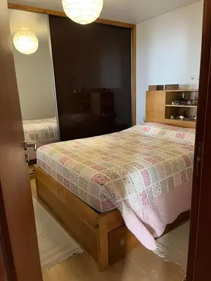 a bedroom with a bed and a mirror at Casa Maria in Ribeira Brava