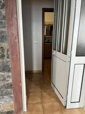 a hallway with a door leading to a kitchen at Casa Maria in Ribeira Brava