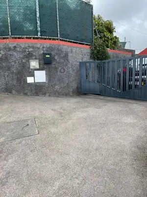 a blue gate in front of a building at Casa Maria in Ribeira Brava