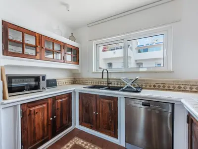 a kitchen with a sink and a microwave at Casa N.º 1 in Luz