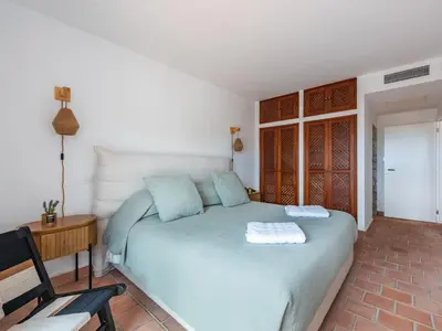 a bedroom with a bed and a table and a chair at Casa N.º 1 in Luz