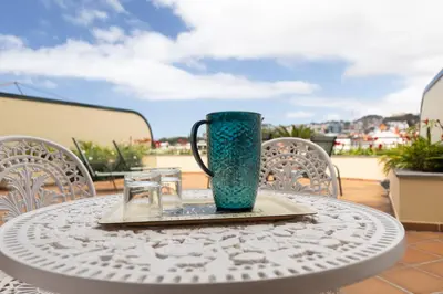 a green vase sitting on top of a table at Anadia Penthouse Duplex by Rent-a-key in Funchal