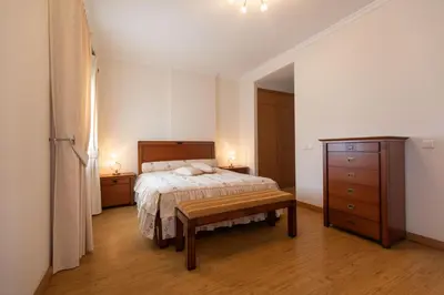 a bedroom with a bed and a dresser at Anadia Penthouse Duplex by Rent-a-key in Funchal