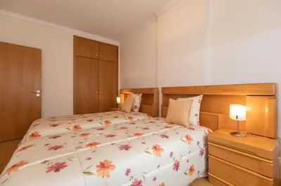 a bedroom with a large bed with a floral bedspread at Anadia Penthouse Duplex by Rent-a-key in Funchal