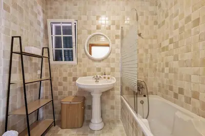 a bathroom with a sink and a mirror and a tub at Amendoeira Residence by Homie in Ponta do Sol