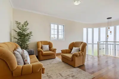 a living room with two chairs and a couch at Amendoeira Residence by Homie in Ponta do Sol