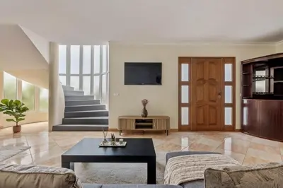 a living room with a couch and a table at Amendoeira Residence by Homie in Ponta do Sol