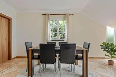a dining room with a table and chairs at Amendoeira Residence by Homie in Ponta do Sol