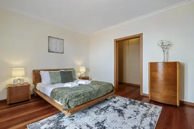 a bedroom with a bed and a dresser in it at Amendoeira Residence by Homie in Ponta do Sol