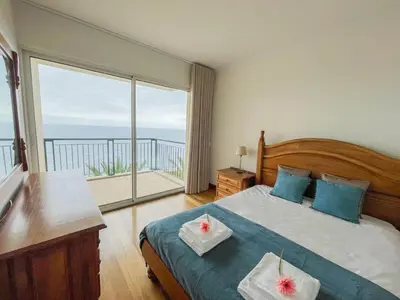 a bedroom with a bed and a large window at Casa Delores, by Specialstays in Funchal