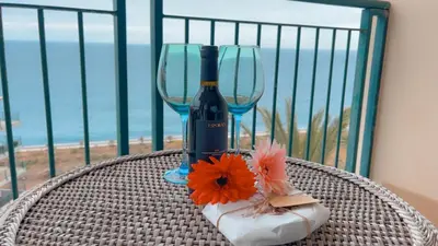 a table with a bottle of wine and two glasses at Casa Delores, by Specialstays in Funchal