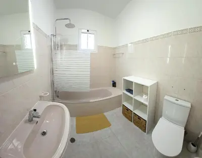 a bathroom with a sink and a toilet and a tub at Moradia em Ponta do Sol 2 Quartos in Ponta do Sol