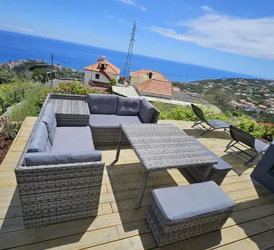 a patio with a couch and a table and chairs at Moradia em Ponta do Sol 2 Quartos in Ponta do Sol