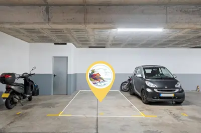 a parking lot with a small car and a motorcycle at Madalenas Holiday Retreat - Free Parking in Funchal in Funchal