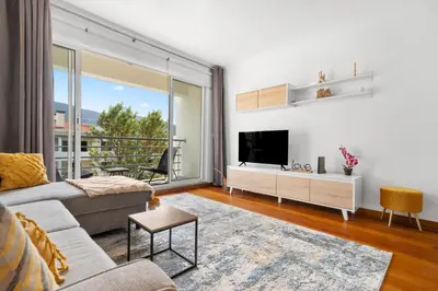 a living room with a couch and a tv at Madalenas Holiday Retreat - Free Parking in Funchal in Funchal