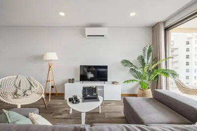 a living room with a couch and a tv at Casa das Raposinhas VII in Funchal