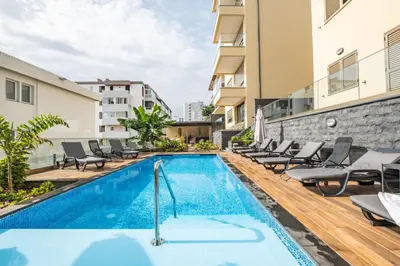 an image of a swimming pool in a building with chairs at Casa das Raposinhas VII in Funchal