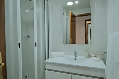 a white bathroom with a sink and a shower at MG Hollidays in Funchal