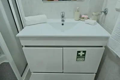 a white bathroom sink with a sign on it at MG Hollidays in Funchal