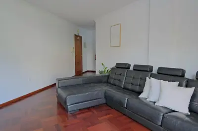a living room with a gray leather couch at MG Hollidays in Funchal