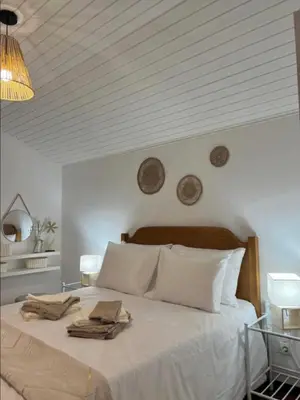 a bedroom with a large white bed with white pillows at Sunny Calheta Apartment MQ3 & Mountain View & Near Beach in Calheta