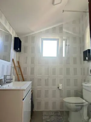 a white bathroom with a toilet and a sink at Sunny Calheta Apartment MQ3 & Mountain View & Near Beach in Calheta