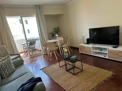 a living room with a couch and a flat screen tv at Aqua City Center in Funchal