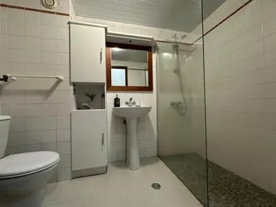 a bathroom with a toilet and a sink and a shower at Aqua City Center in Funchal