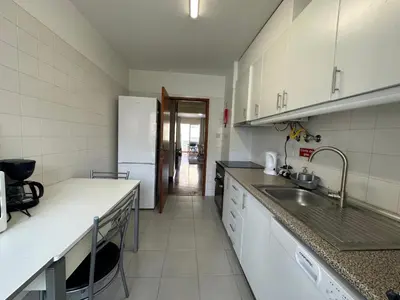 a kitchen with a sink and a refrigerator at Aqua City Center in Funchal