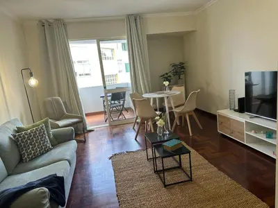 a living room with a couch and a tv and a table at Aqua City Center in Funchal