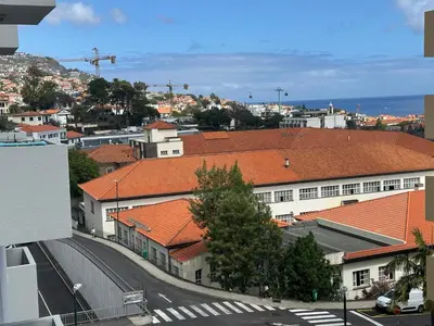 an overhead view of a city with buildings and a street at Aqua City Center in Funchal