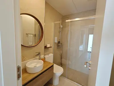 a kitchen with white cabinets and a sink at Social Lodge Cabouqueira Studios in Funchal