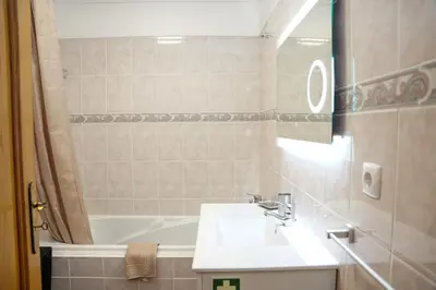 a bathroom with a sink and a bath tub at Rosária Flat in Santa Cruz