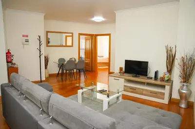 a living room with a couch and a television at Rosária Flat in Santa Cruz