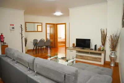 a living room with a couch and a television at Rosária Flat in Santa Cruz