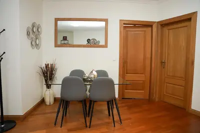 a dining room with a table and chairs and a mirror at Rosária Flat in Santa Cruz